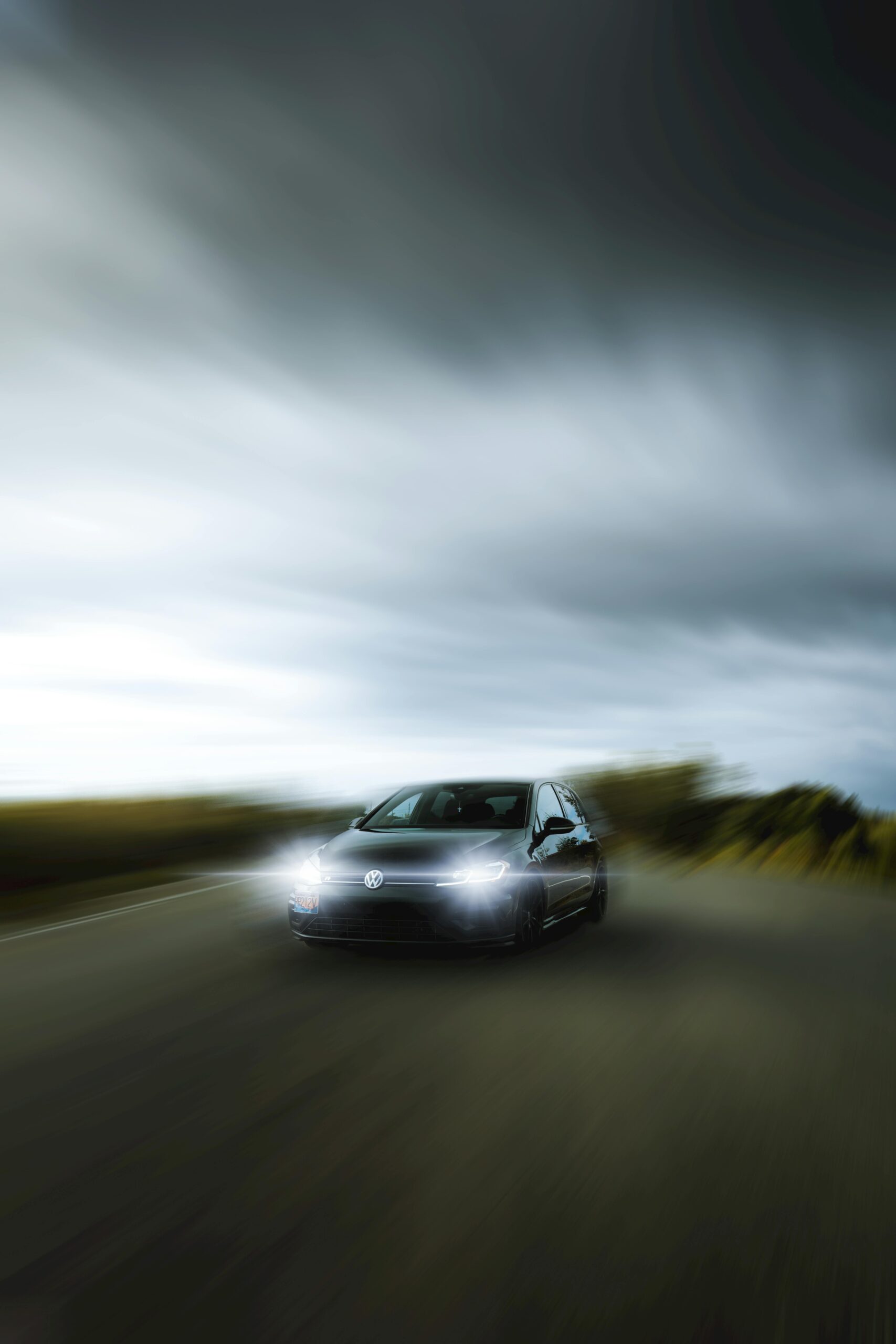 Experience the speed and thrill of a car in motion on a scenic road, captured with dynamic motion blur.